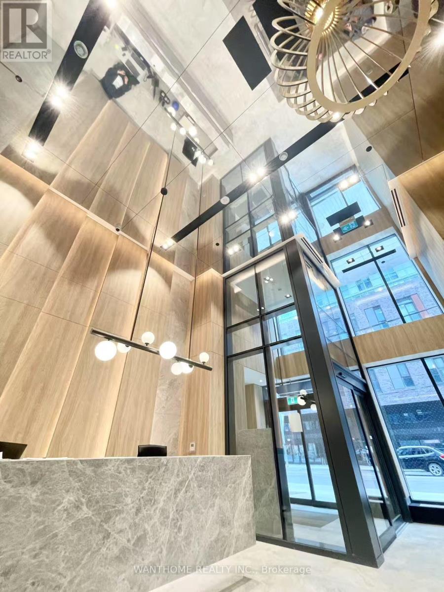A modern interior with wooden walls and a glass elevator.
