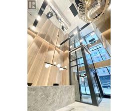 A modern interior with wooden walls and a glass elevator.
