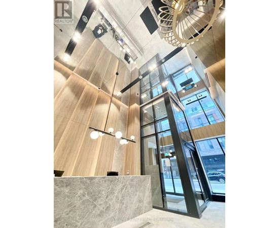 A modern interior with wooden walls and a glass elevator.