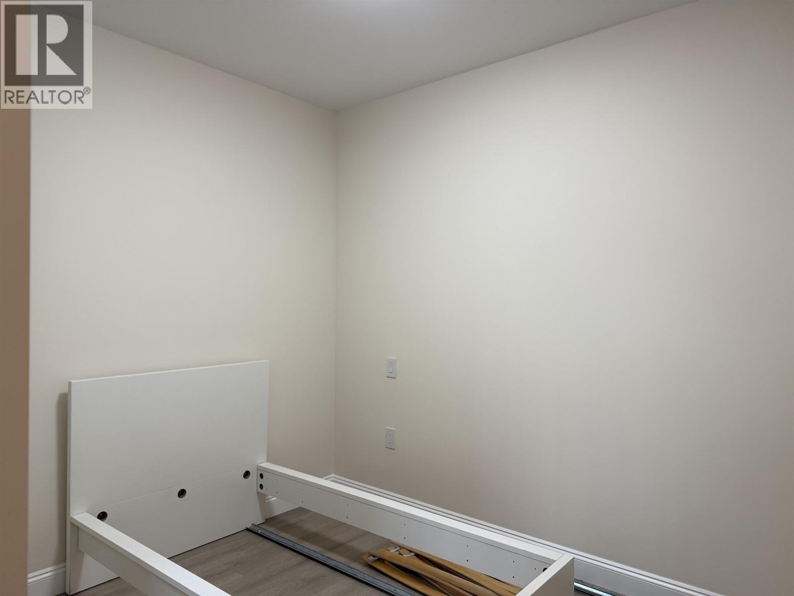 A white door is in the middle of a room.