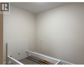 A white door is in the middle of a room.