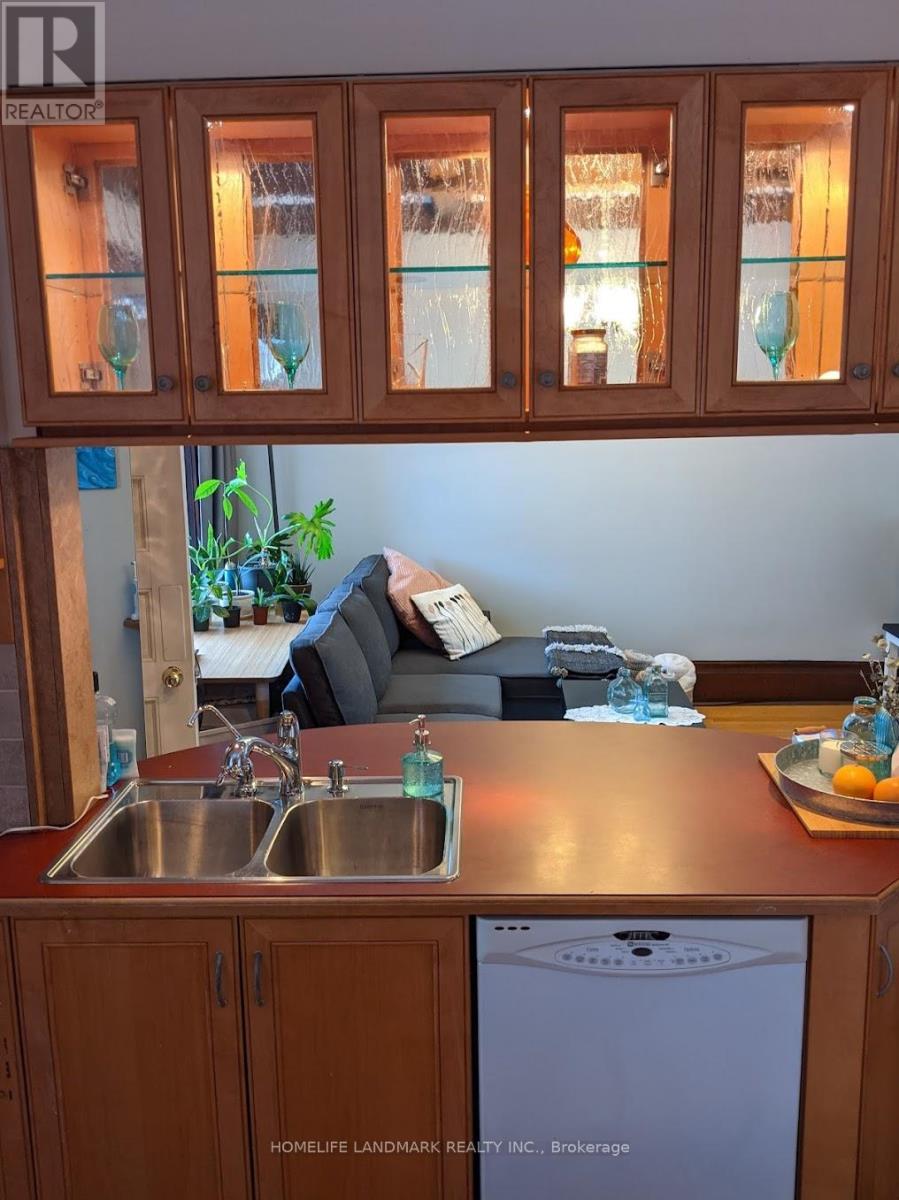 A kitchen with wooden cabinets and a washing machine.