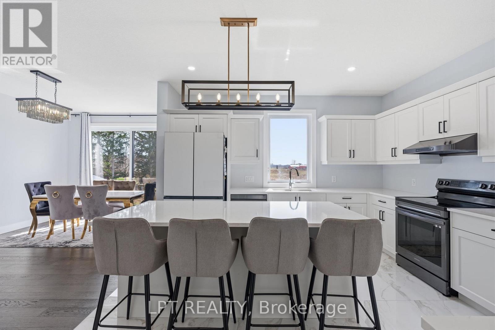 A modern kitchen with a dining table set for four.