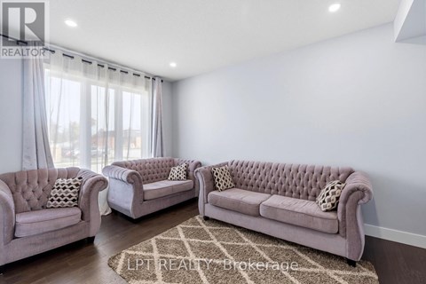A living room with two couches and a rug.