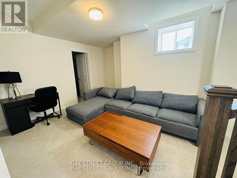 A living room with a grey couch and a wooden coffee table.