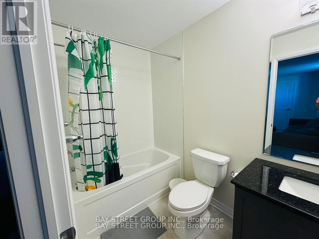 A small bathroom with a toilet, sink and shower.