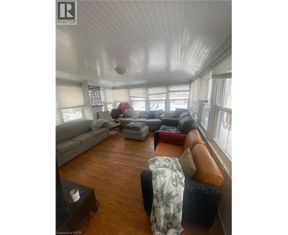 A living room with a grey couch and a brown leather chair.