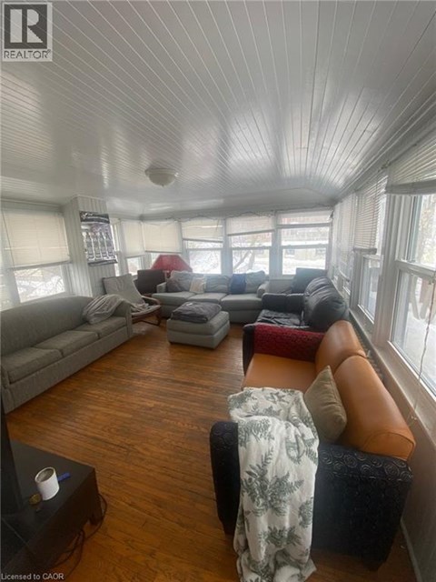 A living room with a grey couch and a brown leather chair.