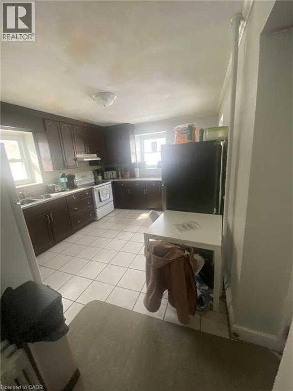 A kitchen with a white fridge and a white dishwasher.