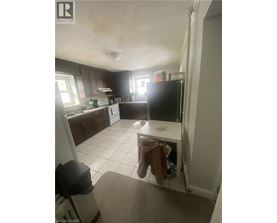 A kitchen with a white fridge and a white dishwasher.