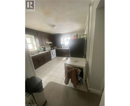 A kitchen with a white fridge and a white dishwasher.