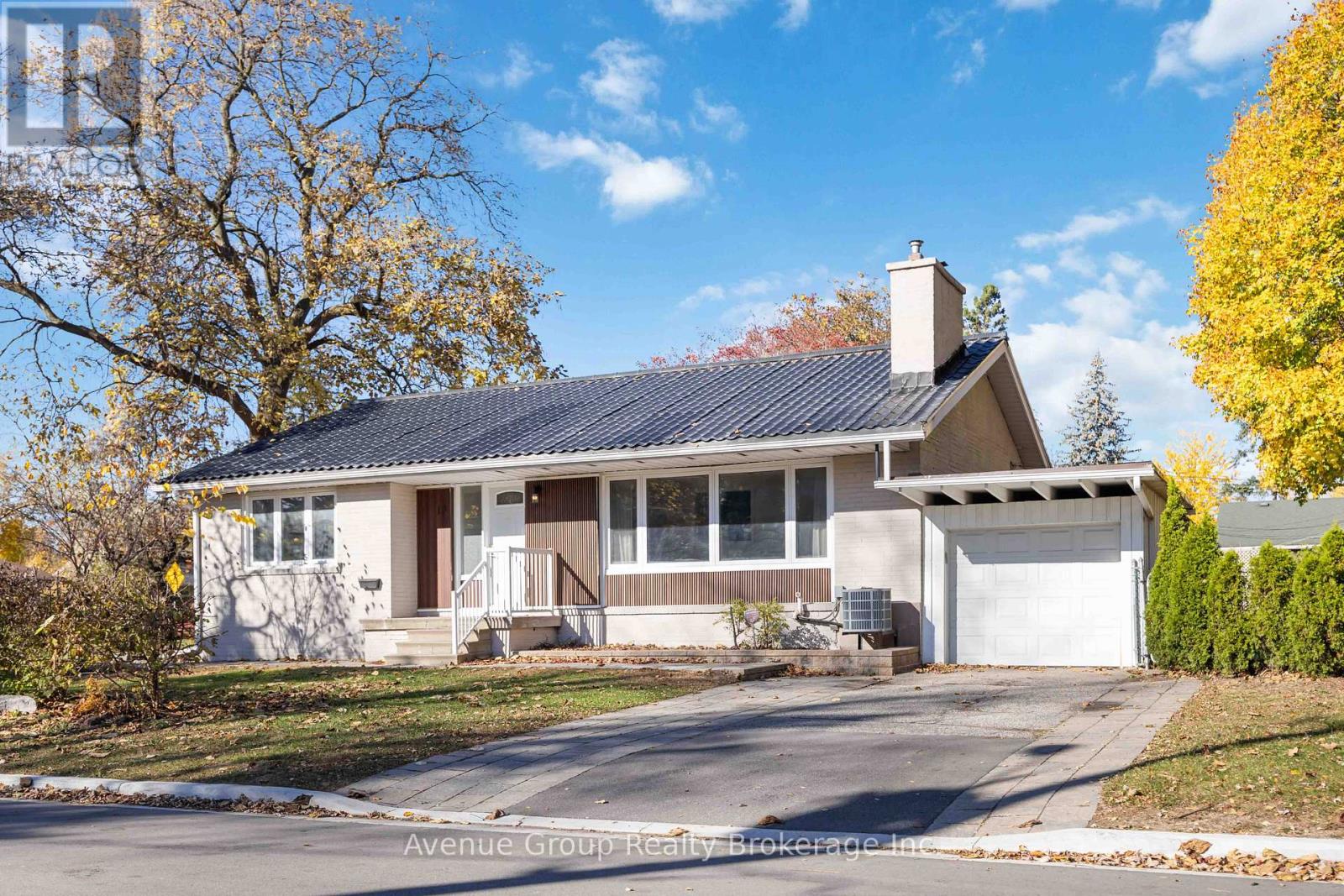 A house with a garage and a driveway in front.