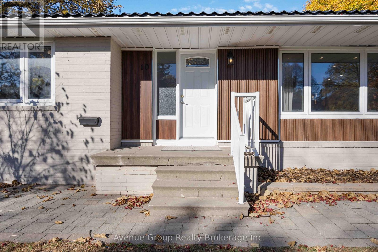 A house with a brown and white exterior and a white door.