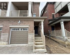 A building with a garage door and stairs leading to it.
