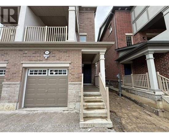 A building with a garage door and stairs leading to it.
