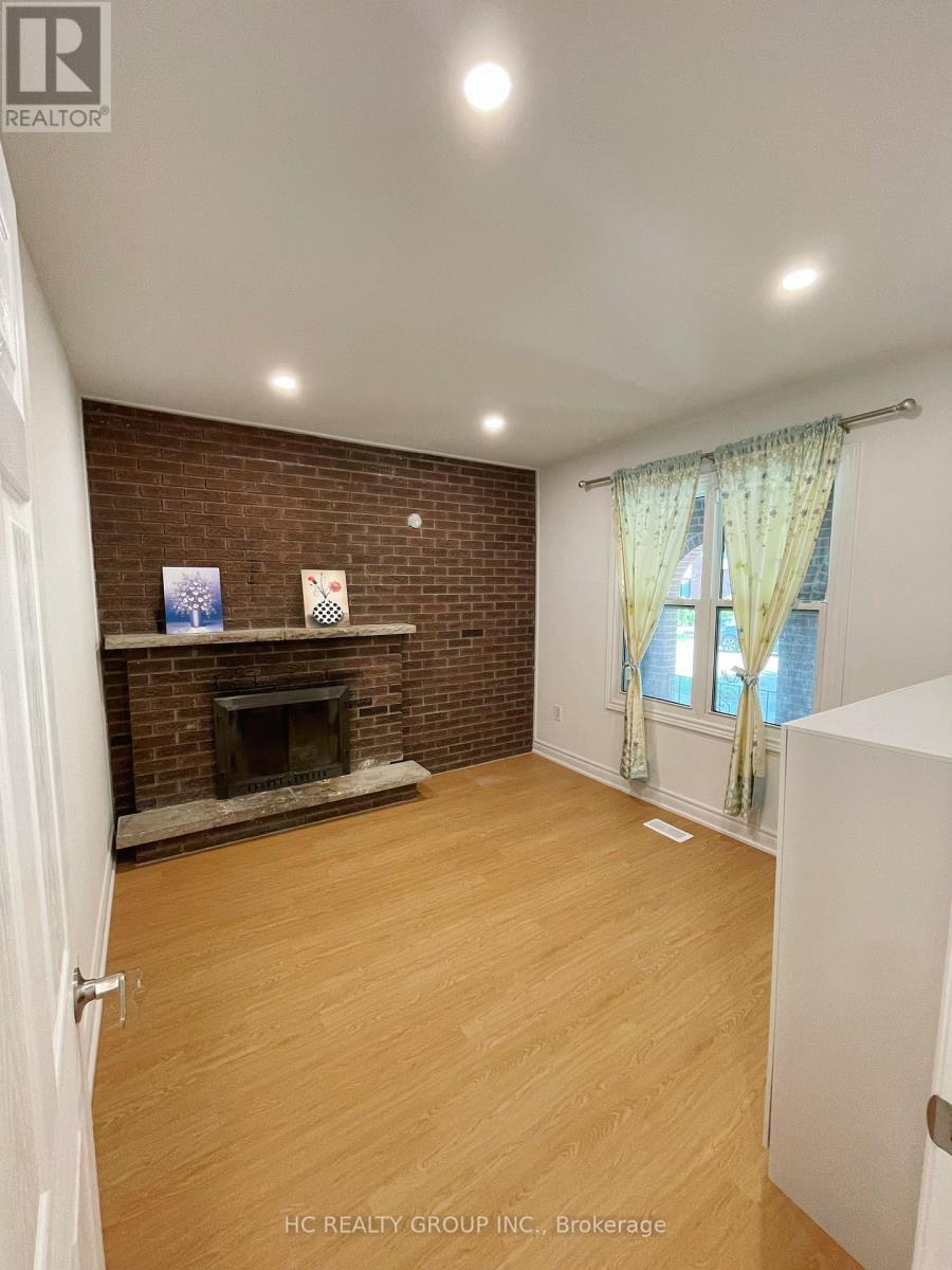 A room with a fireplace and a window with curtains.