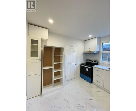 A kitchen with white cabinets and a blue dishwasher.