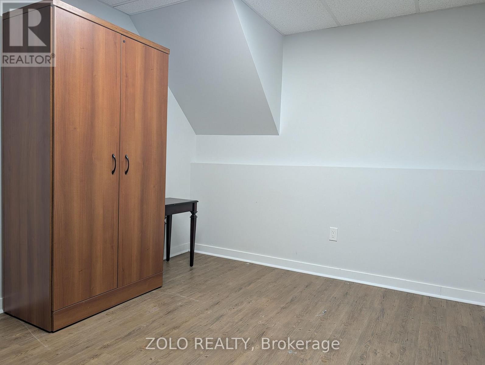 A room with a wooden cabinet and a small table.