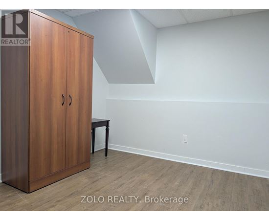 A room with a wooden cabinet and a small table.