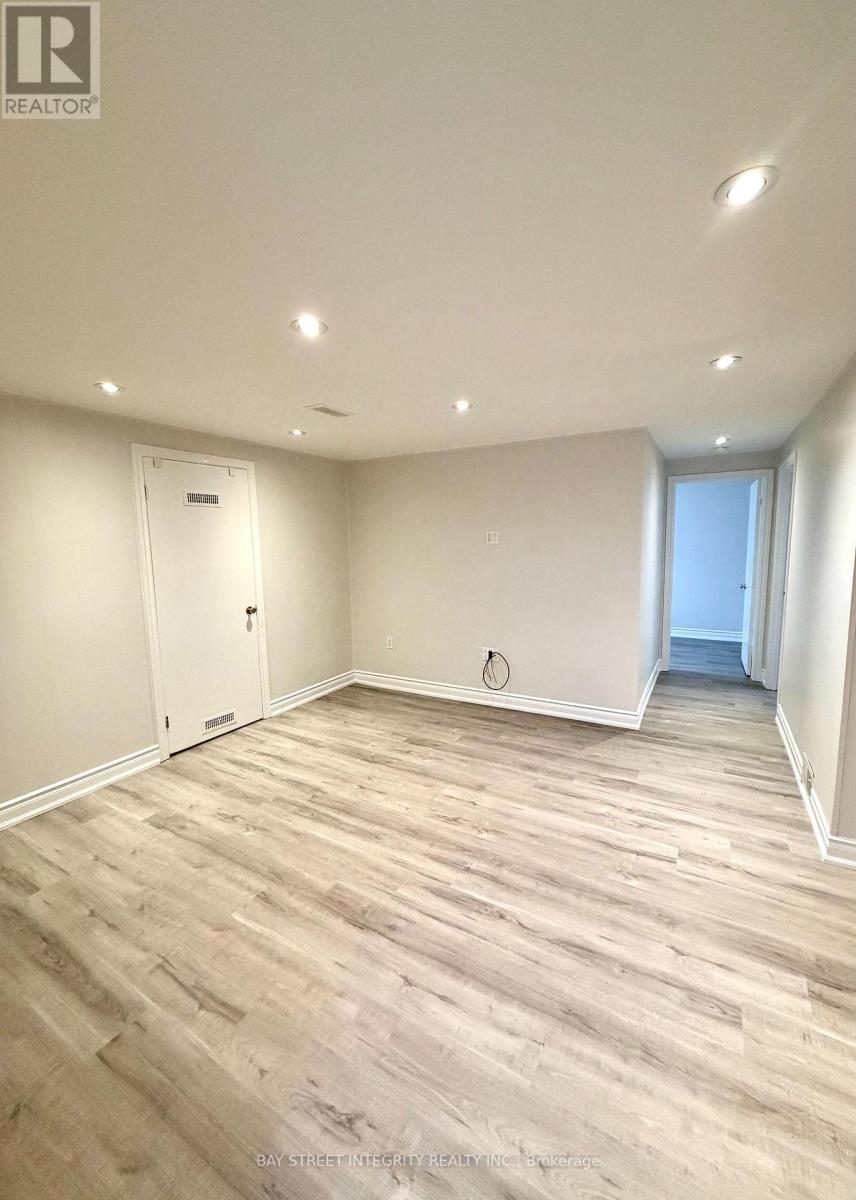 A room with wooden flooring and white walls.
