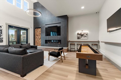 A modern living room with a pool table and a fireplace.