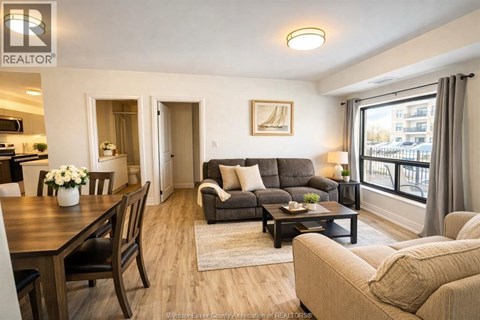A well-lit living room with a dining table and a couch.