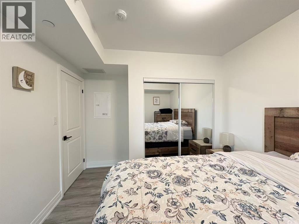 A bedroom with a large bed and a mirror on the wall.