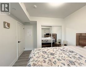 A bedroom with a large bed and a mirror on the wall.