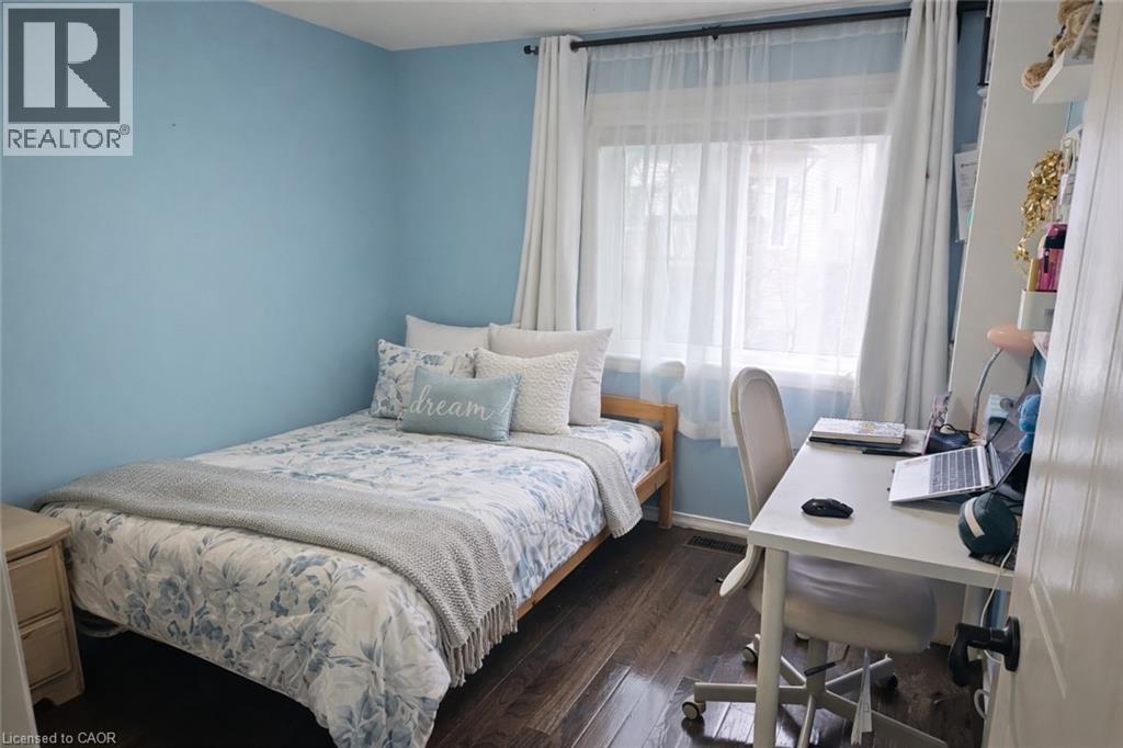 A bedroom with a bed, desk, and chair.