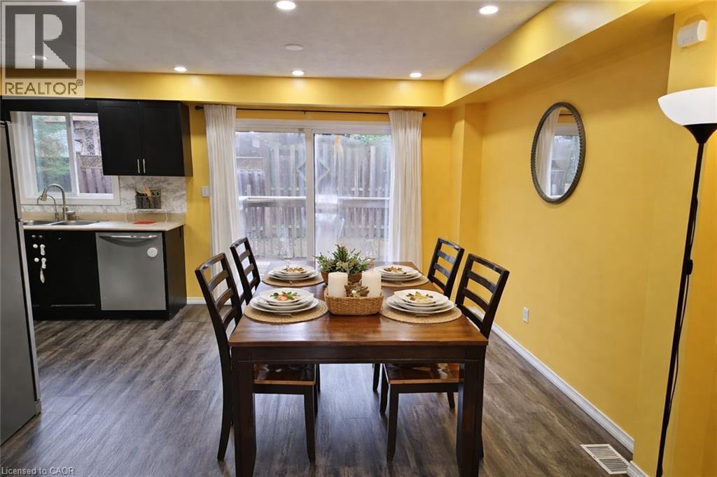 A dining room with a table set for four.