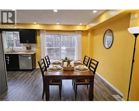 A dining room with a table set for four.