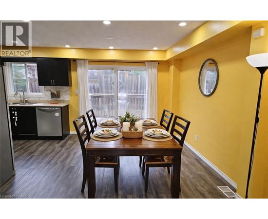 A dining room with a table set for four.