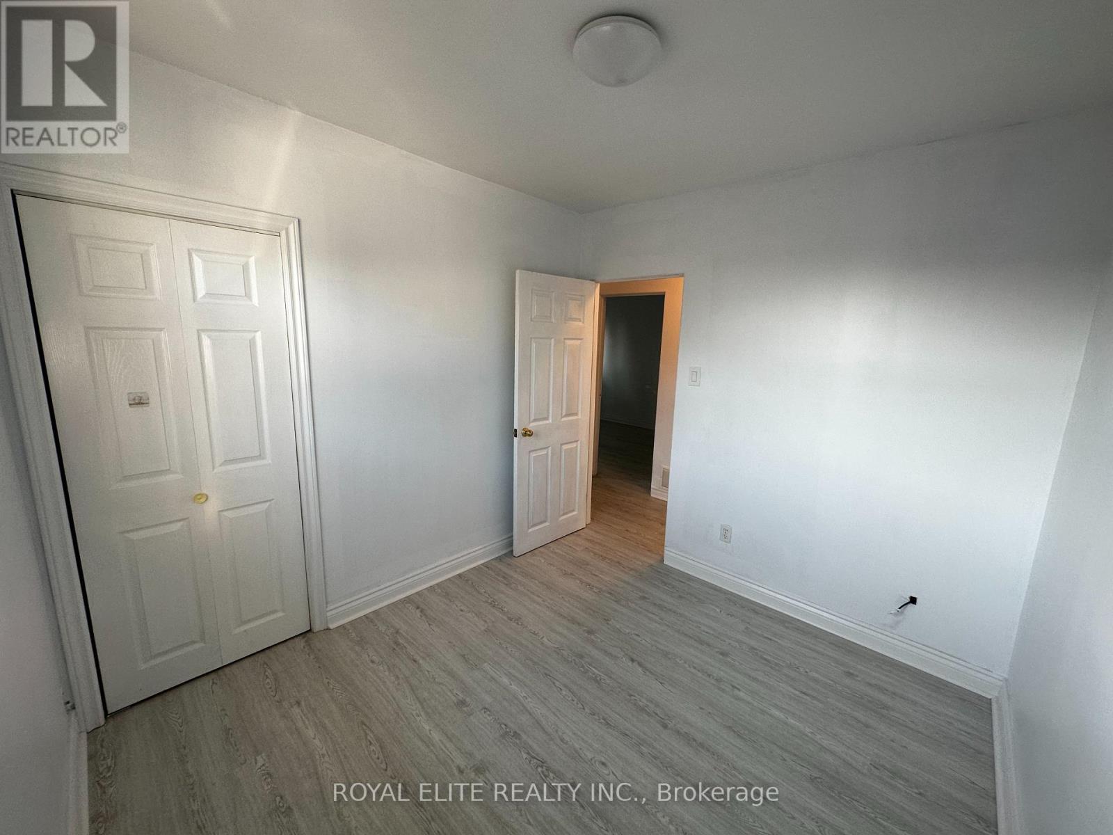 A white door is on the left and a brown door is on the right.
