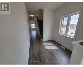 A hallway with wooden floors and white walls.
