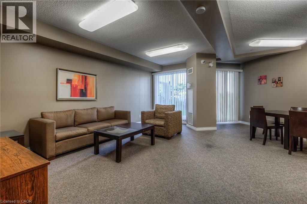 A living room with a brown sofa, a coffee table, and a painting on the wall.