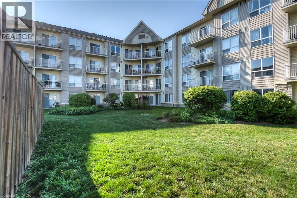 A well-maintained lawn in front of a multi-story apartment building.