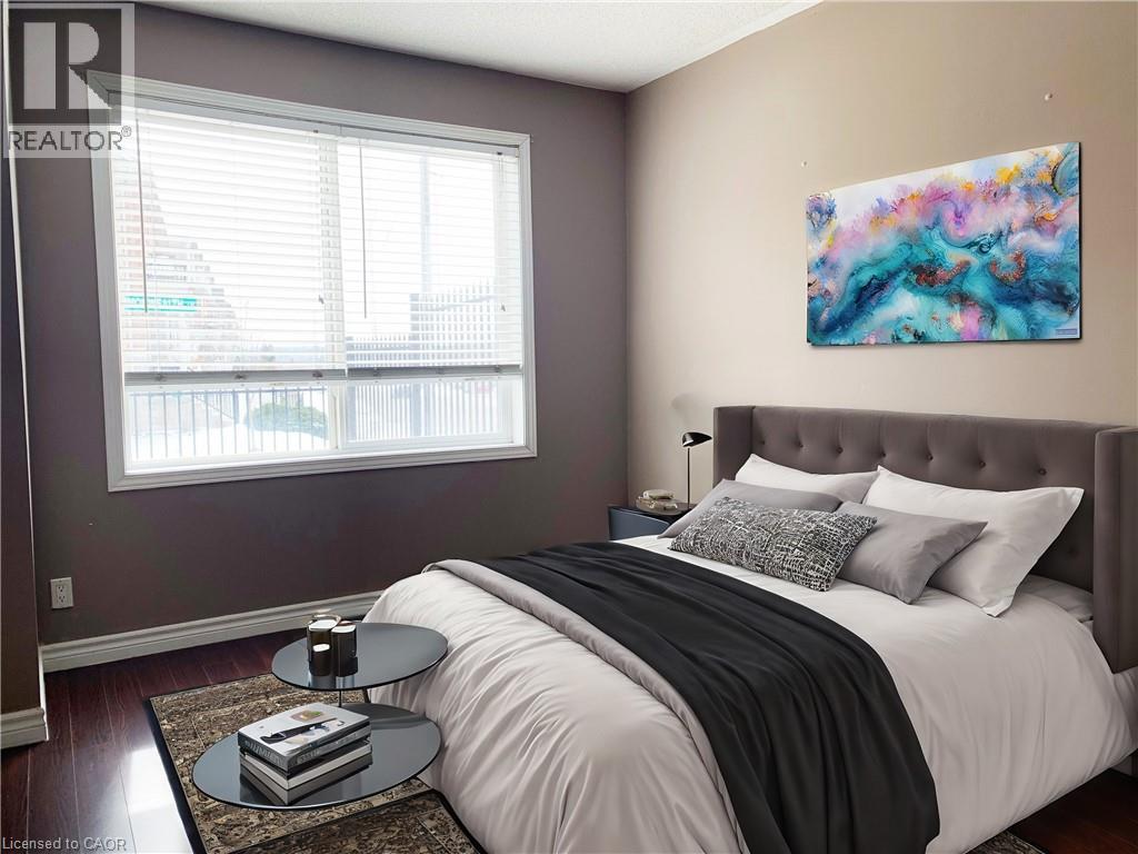 A bedroom with a large bed and a painting on the wall.