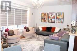 A living room with a grey couch and a white couch.