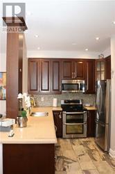 A kitchen with wooden cabinets and stainless steel appliances.