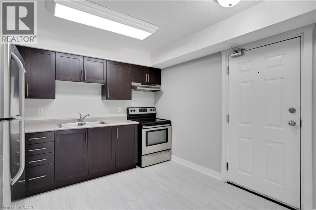 A kitchen with dark brown cabinets and white appliances.