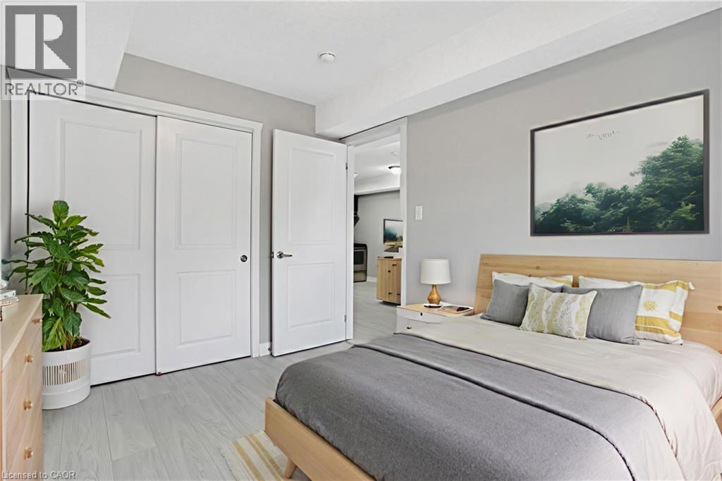A bedroom with a bed, nightstand, and a potted plant.