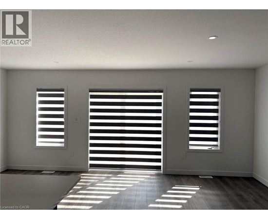 A room with a sliding door and two windows.