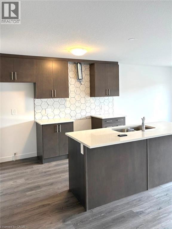 A kitchen with a white counter top and brown cabinets.