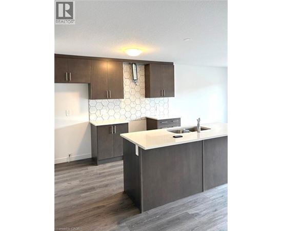 A kitchen with a white counter top and brown cabinets.