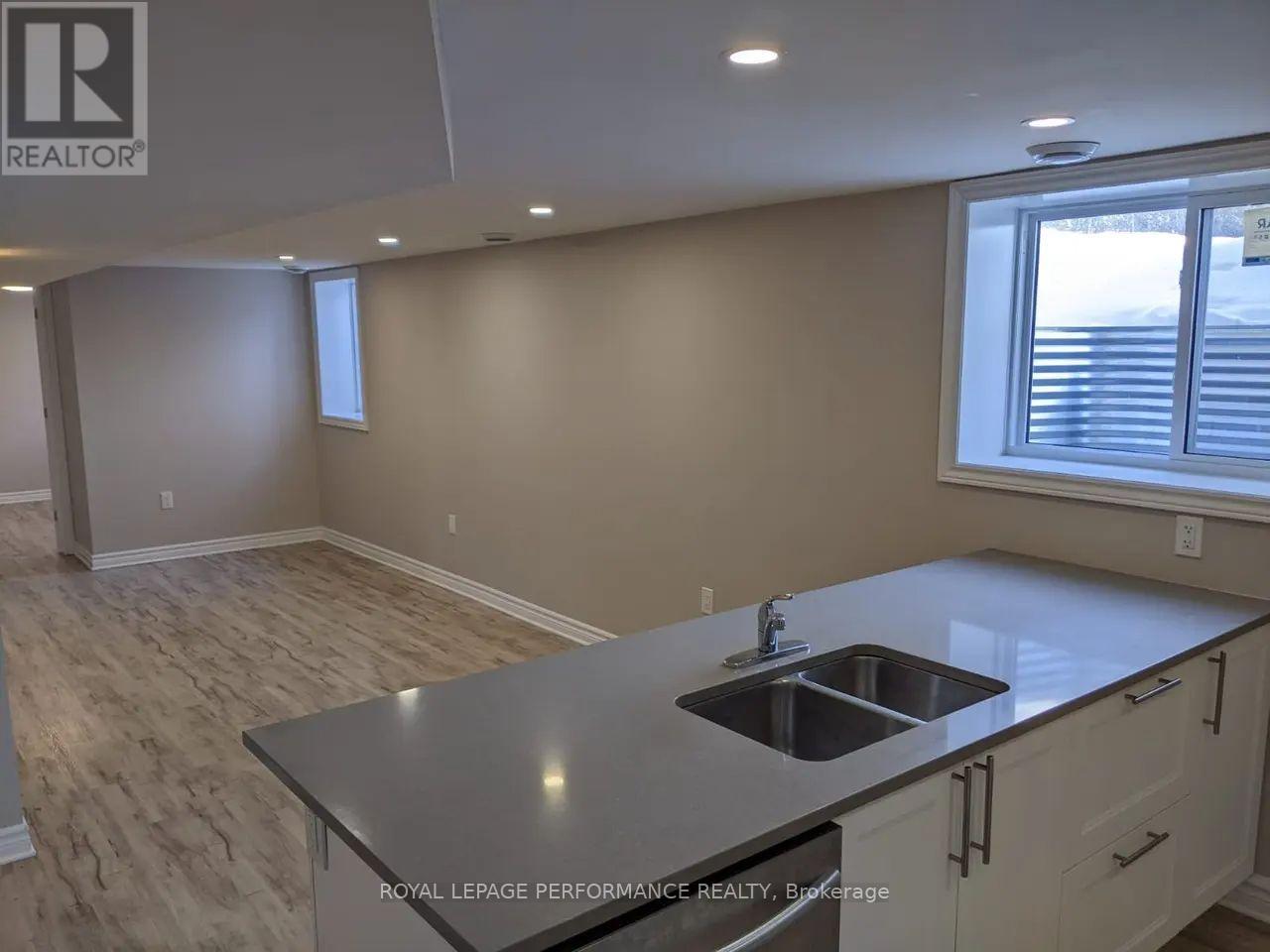 A kitchen with a sink and a window.