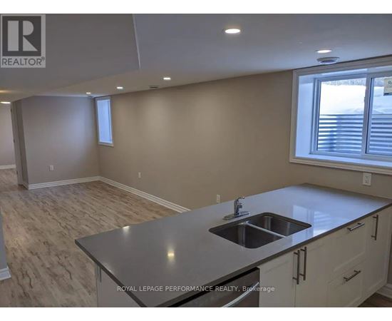 A kitchen with a sink and a window.