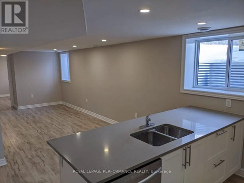 A kitchen with a sink and a window.