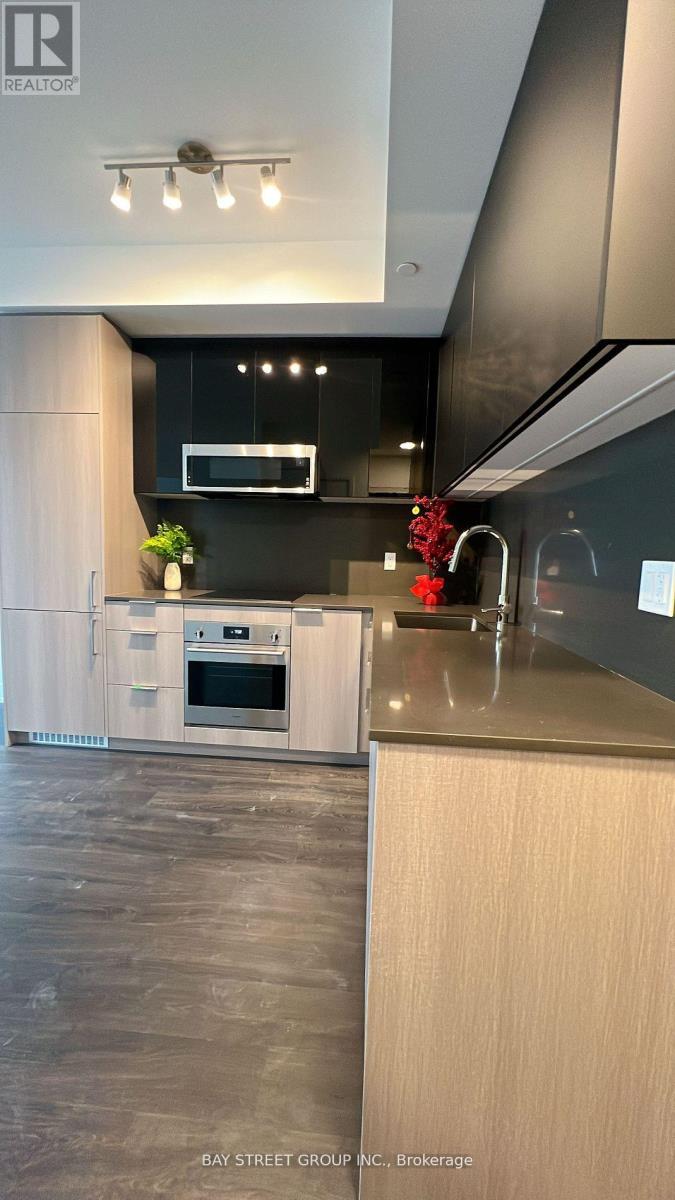 A modern kitchen with a white oven and wooden cabinets.