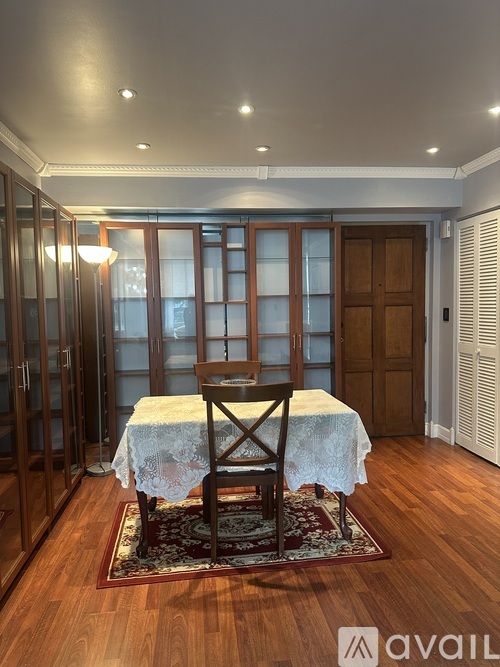 A dining room with a table and chairs.