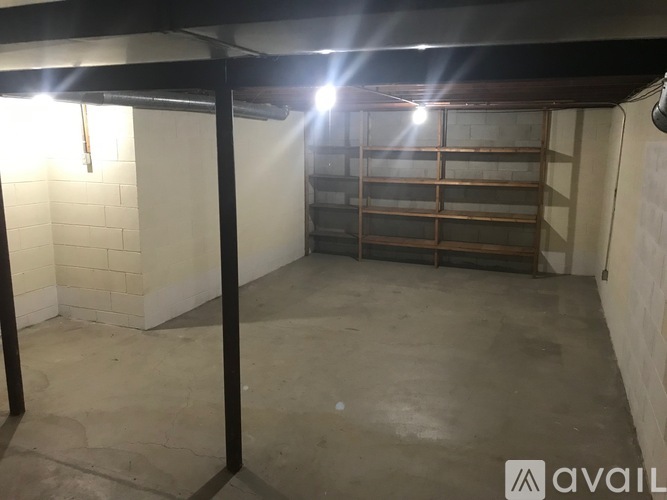 A spacious garage with a concrete floor and a brick wall.